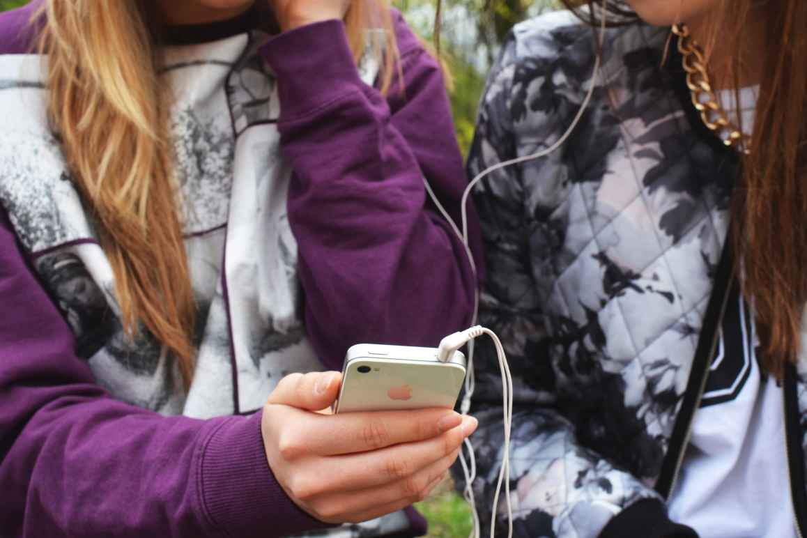 Teens holding cellphone privacy