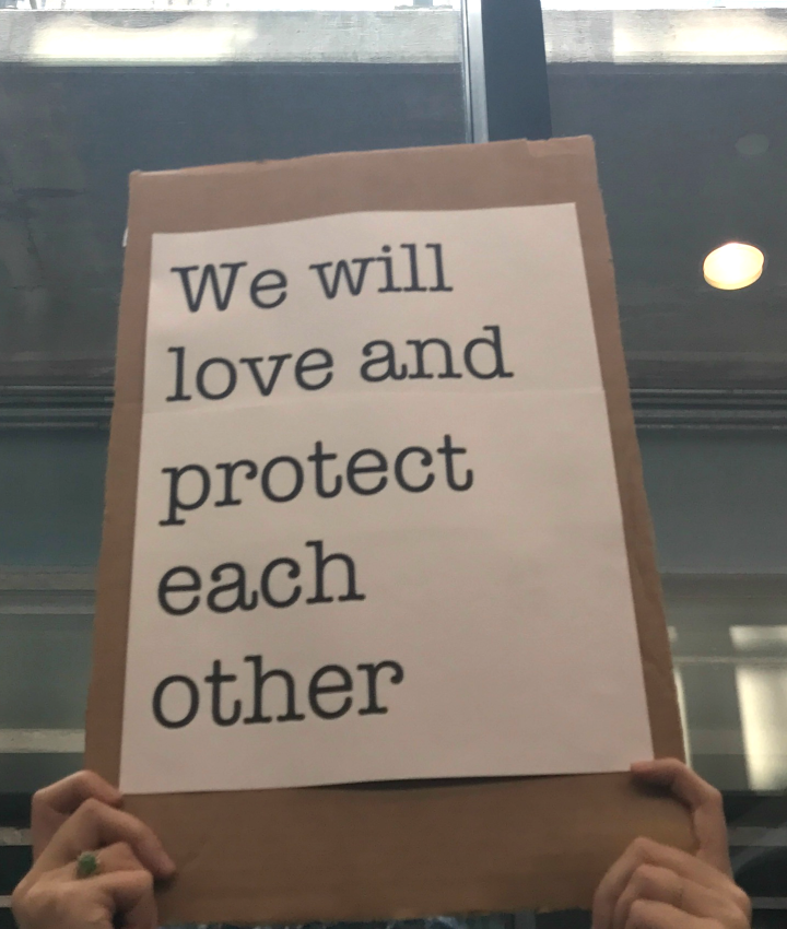 We will love and protect each other sign at Bradley Airport protest against Trump Administration&#039;s Muslim ban
