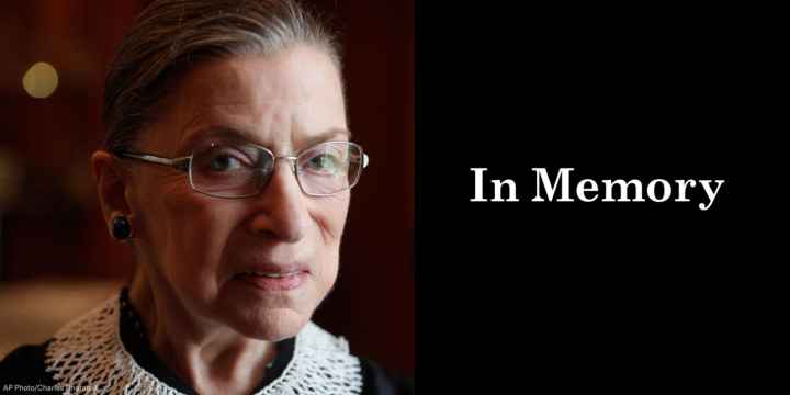A close up photo of Supreme Court Justice Ruth Bader Ginsburg is on the left. She is looking directly at the camera. On the right, a black box. In the box, "in memory" is written in white letters.