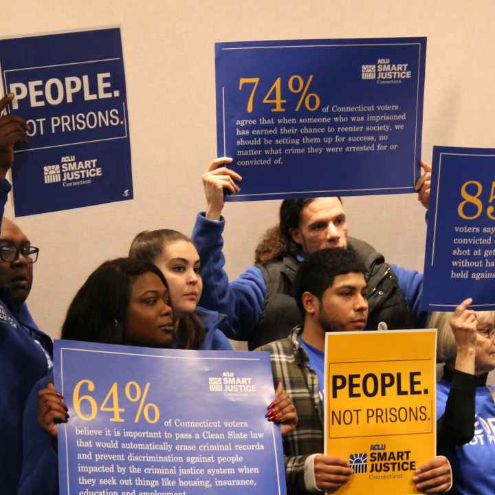 ACLU-CT Smart Justice leaders stand with "people not prisons" posters at a Connecticut Clean Slate pres conference