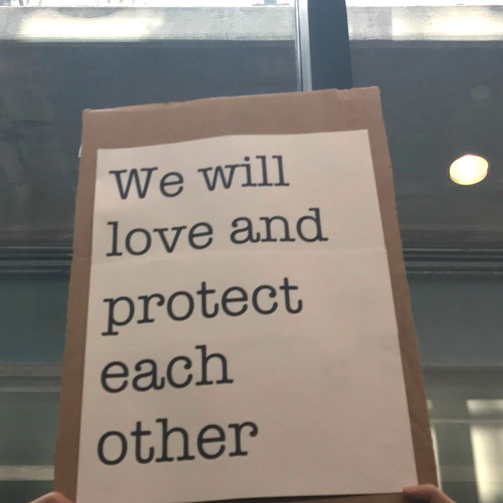 We will love and protect each other sign at Bradley Airport protest against Trump Administration&#039;s Muslim ban