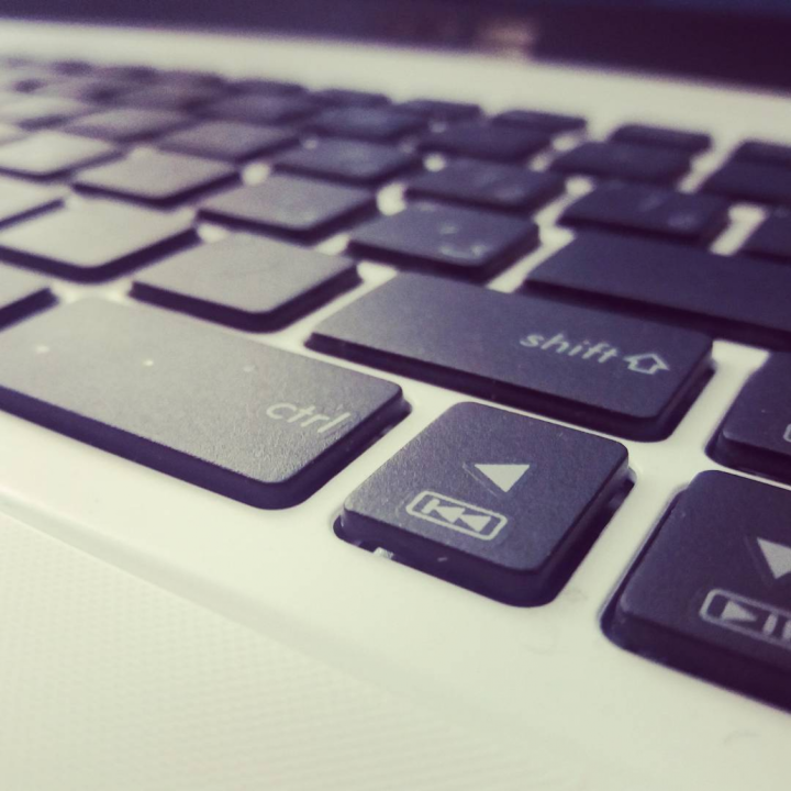 Black and white photo of a keyboard, focus on control, shift, and arrow buttons