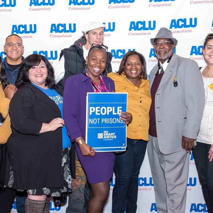 ACLU-CT Smart Justice leaders and Rep. Robyn Porter stand in front of an ACLU of Connecticut banner at the "Smart Justice: Year One" film premiere in New Haven