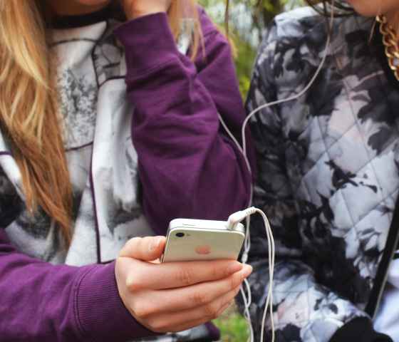 Teens holding cellphone privacy